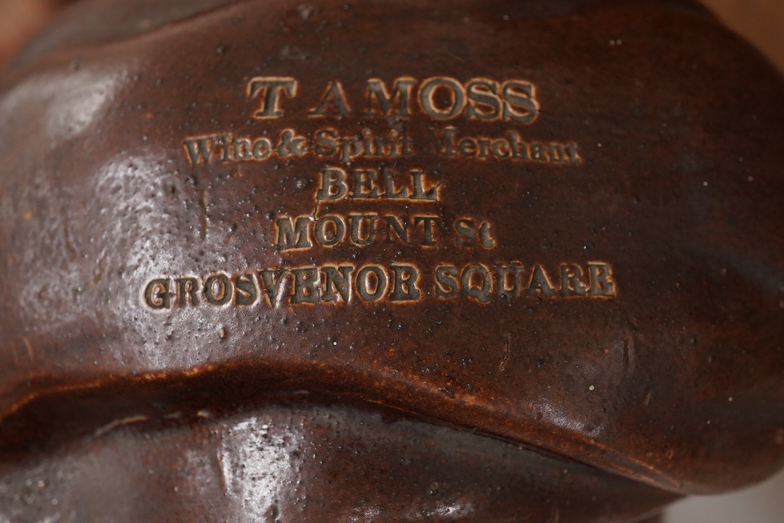 A large 19th century Johnny Souter, salt glazed stoneware spirit flask impressed T A Moss wine and spirit Merchant Bell Mount street Grosvenor square, 28cm high